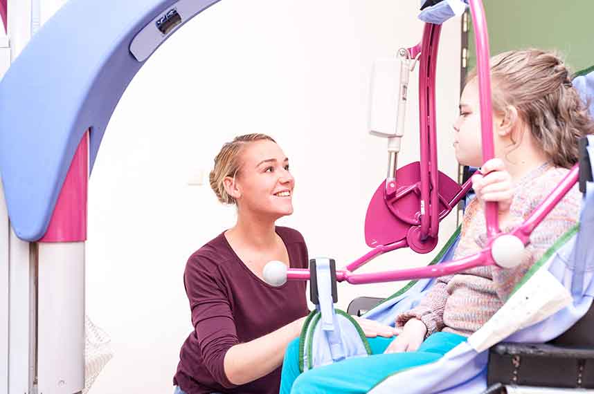 Picture of a carer looking after a client in a disability care home